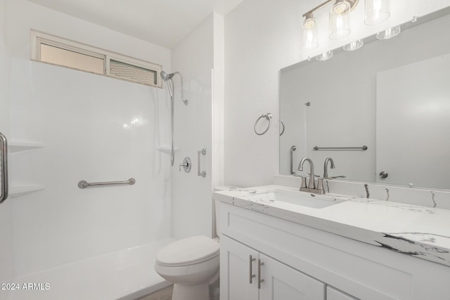 bathroom with vanity, toilet, and walk in shower