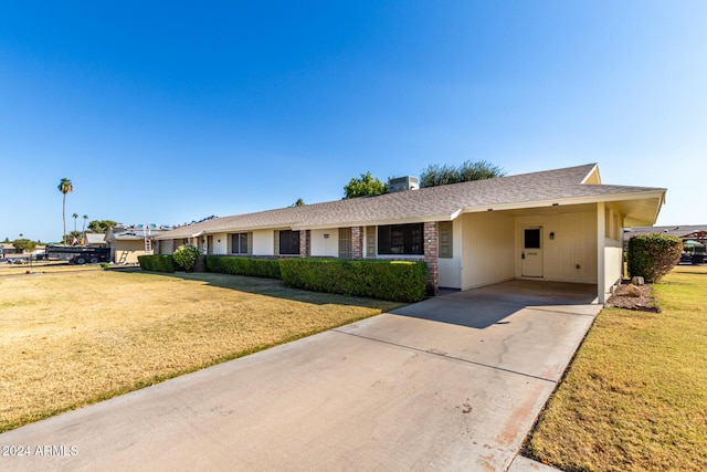 ranch-style house with a carport and a front yard