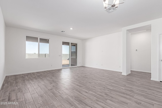 spare room with light hardwood / wood-style floors