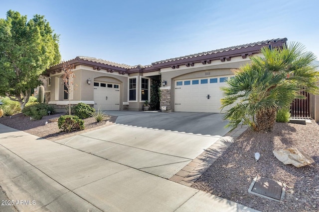2413 W Kachina Trl, Phoenix, AZ 85041 - mediterranean / spanish-style house featuring stucco siding, an attached garage, concrete driveway, and a tile roof