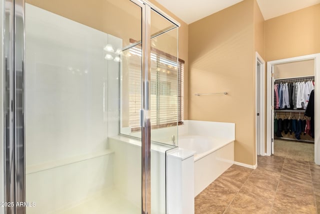 2413 W Kachina Trl, Phoenix, AZ 85041 - bathroom with a bath, a stall shower, and a walk in closet