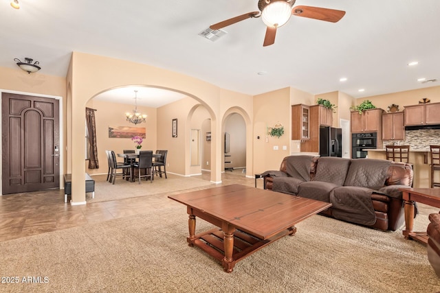2413 W Kachina Trl, Phoenix, AZ 85041 - living room with arched walkways, a ceiling fan, recessed lighting, a chandelier, and light tile patterned floors