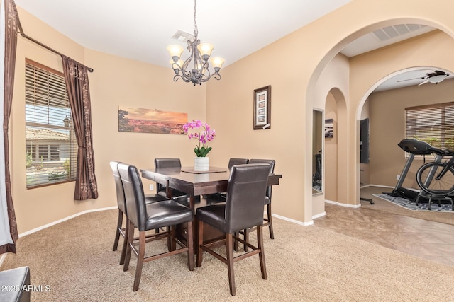 2413 W Kachina Trl, Phoenix, AZ 85041 - dining area featuring arched walkways, carpet, and a chandelier