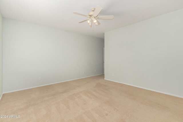 unfurnished room featuring light colored carpet and ceiling fan