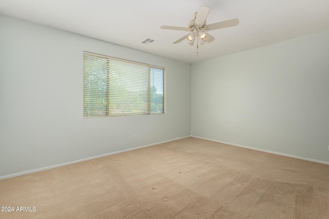 empty room with light colored carpet and ceiling fan