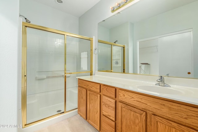 bathroom with vanity and a shower with shower door