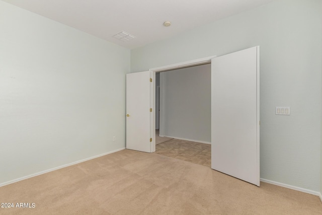 unfurnished bedroom with light carpet