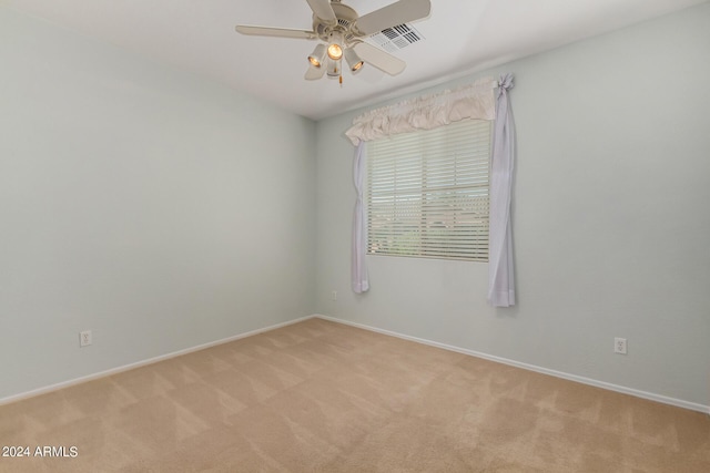 empty room with light colored carpet and ceiling fan