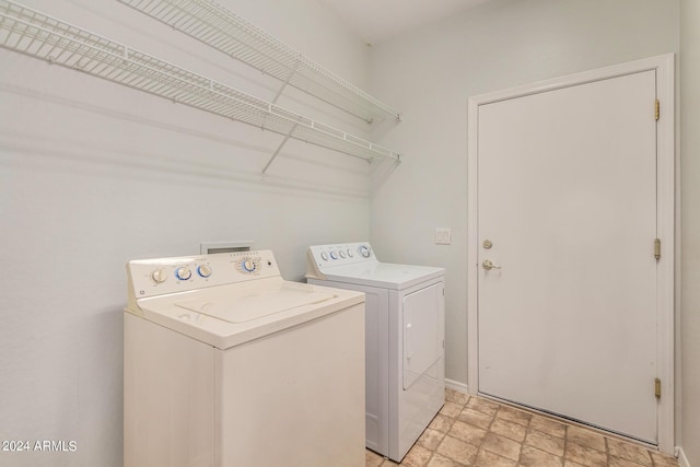 clothes washing area featuring separate washer and dryer