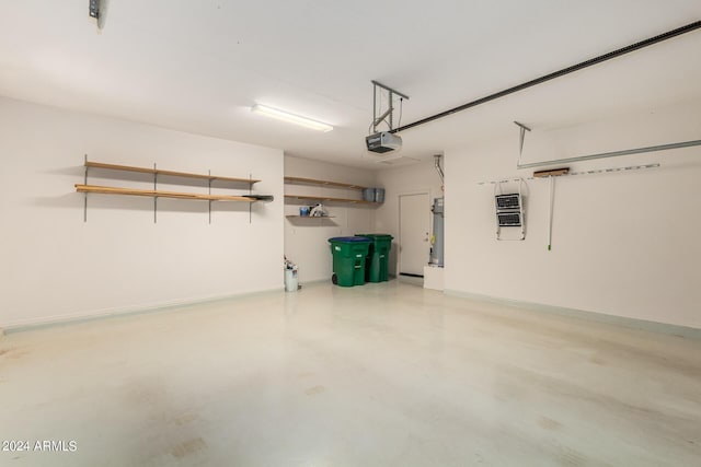 garage featuring a garage door opener and heating unit