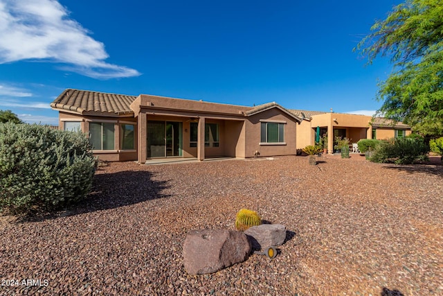 rear view of property featuring a patio area