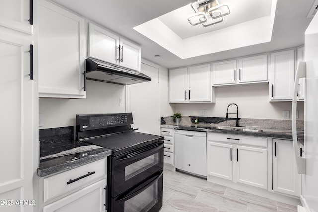 kitchen with dishwasher, sink, white cabinets, a raised ceiling, and range with two ovens