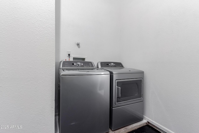 laundry room with washing machine and clothes dryer