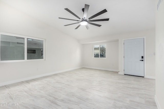 spare room featuring vaulted ceiling and ceiling fan