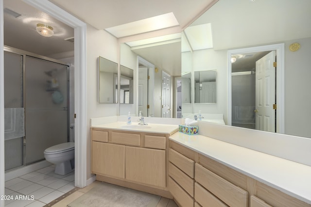 bathroom featuring toilet, tile floors, an enclosed shower, and oversized vanity