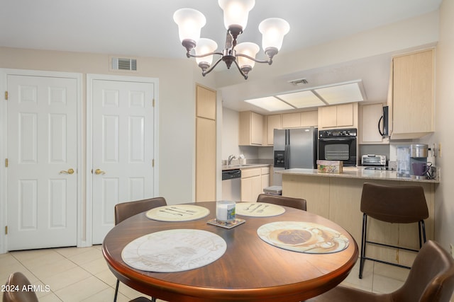 tiled dining room featuring a notable chandelier