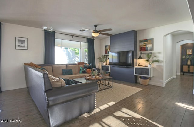 living room with dark hardwood / wood-style floors and ceiling fan