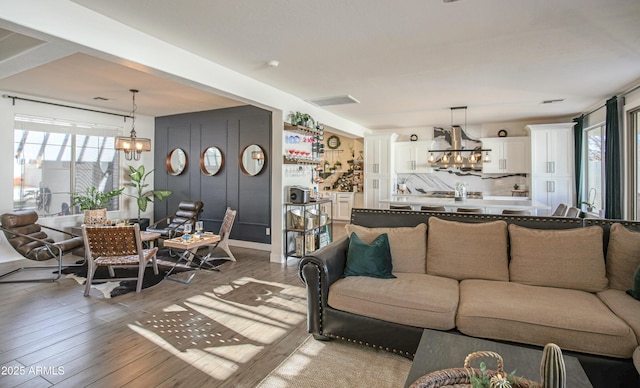 living room featuring an inviting chandelier and hardwood / wood-style floors