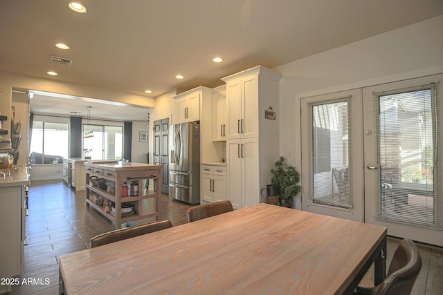 kitchen with pendant lighting, white cabinetry, dark hardwood / wood-style flooring, stainless steel refrigerator with ice dispenser, and french doors