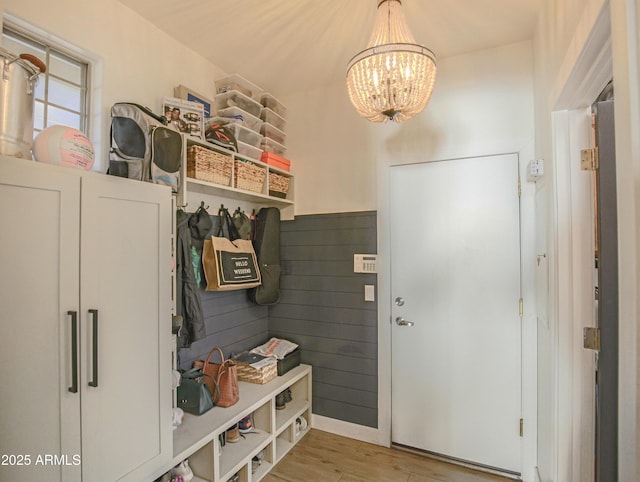 mudroom featuring an inviting chandelier and light hardwood / wood-style floors