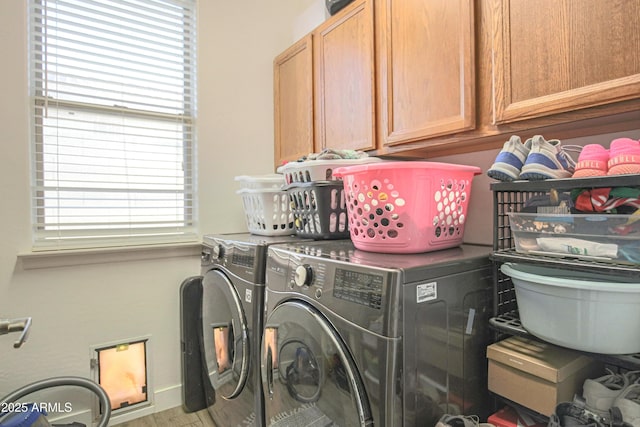 laundry area with washer and dryer and cabinets