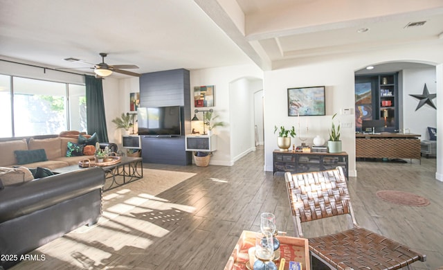 living room featuring hardwood / wood-style floors and ceiling fan