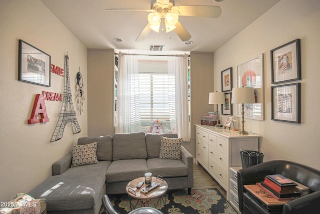 living room featuring ceiling fan and dark hardwood / wood-style flooring