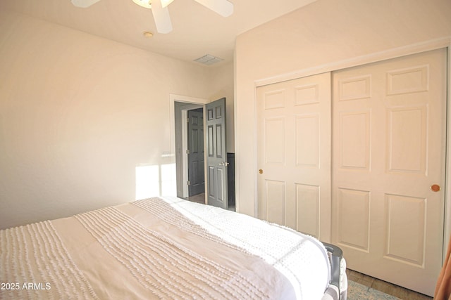 bedroom featuring ceiling fan, hardwood / wood-style floors, and a closet