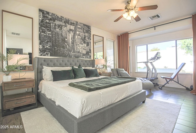 bedroom with wood-type flooring, ceiling fan, and access to outside