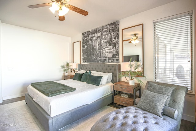 bedroom with ceiling fan and hardwood / wood-style floors