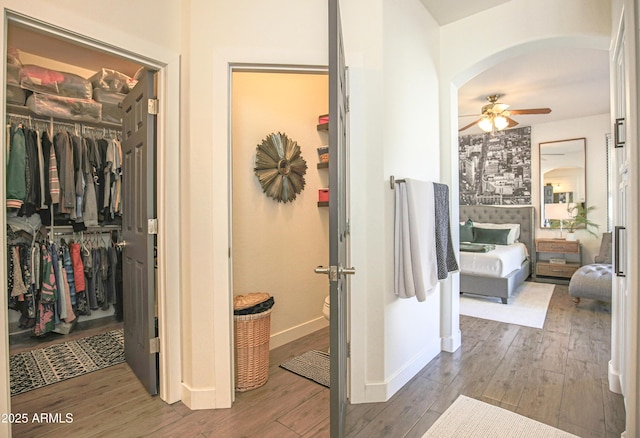 bathroom with wood-type flooring and ceiling fan