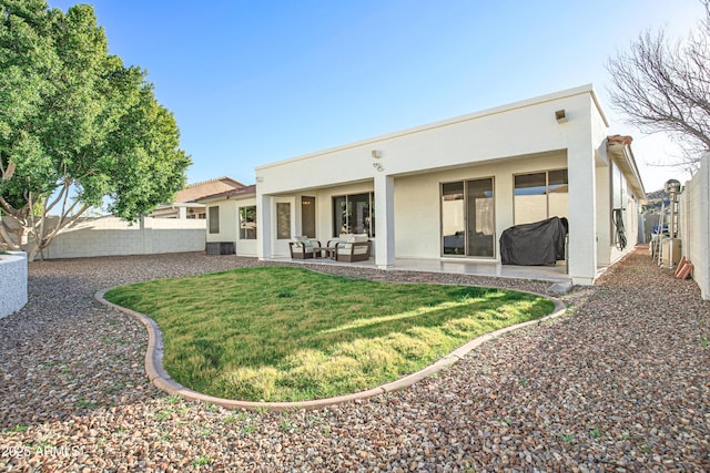 rear view of house with an outdoor hangout area, a patio, and a lawn