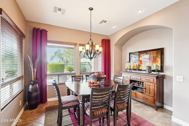 tiled dining area with a chandelier