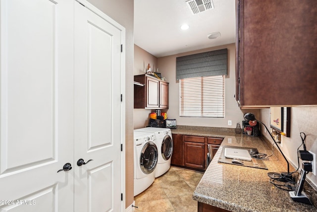 washroom featuring cabinets and washer and dryer