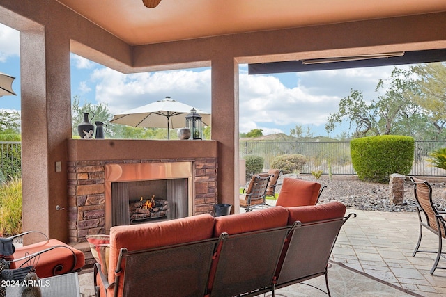 view of patio featuring an outdoor stone fireplace