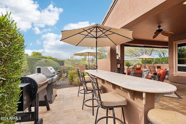 view of patio featuring grilling area, ceiling fan, and an outdoor bar