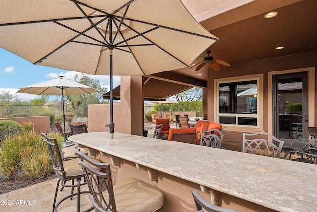 view of patio / terrace featuring an outdoor bar and ceiling fan