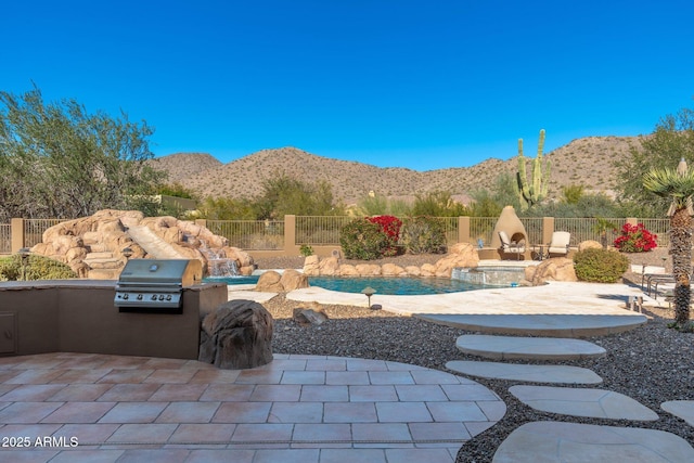 view of patio / terrace featuring a mountain view, a pool with hot tub, grilling area, and area for grilling