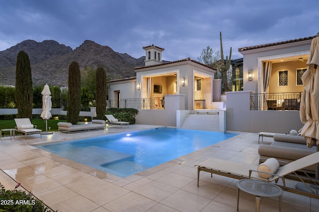 view of pool with a mountain view and a patio