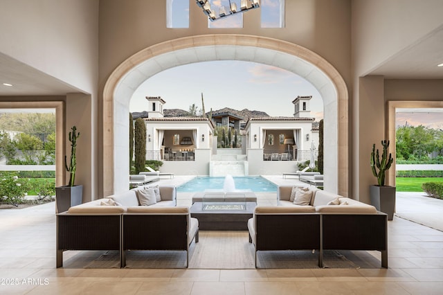 view of patio / terrace with an outdoor living space and pool water feature