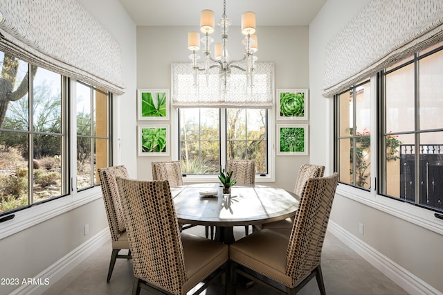 dining area featuring tile patterned flooring, a wealth of natural light, and a notable chandelier