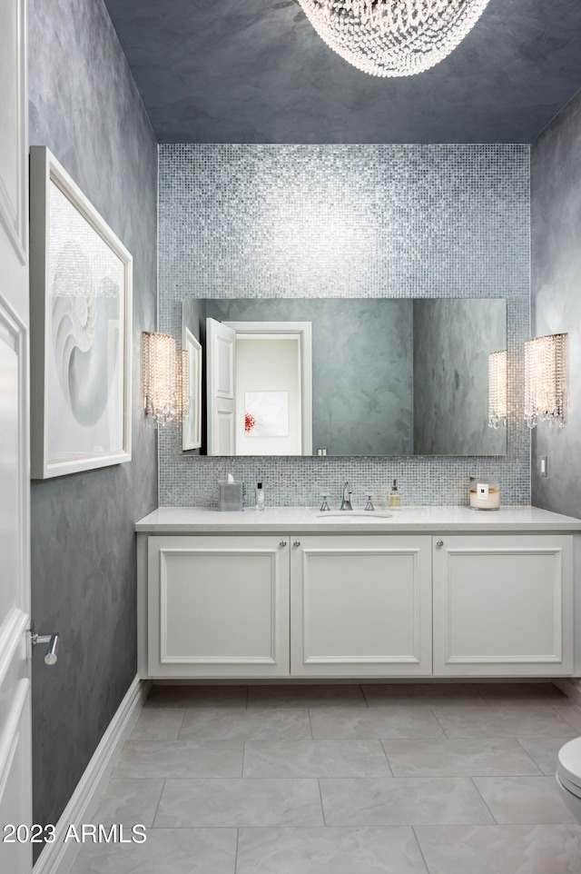 bathroom featuring vanity, tile patterned flooring, and decorative backsplash