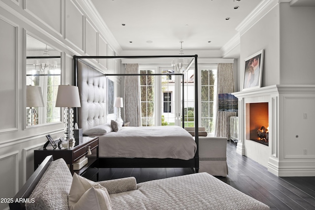 bedroom with multiple windows, ornamental molding, and a notable chandelier