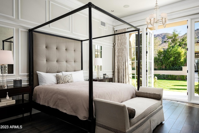 bedroom featuring a notable chandelier, access to outside, and dark hardwood / wood-style floors