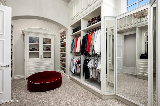 walk in closet with carpet flooring