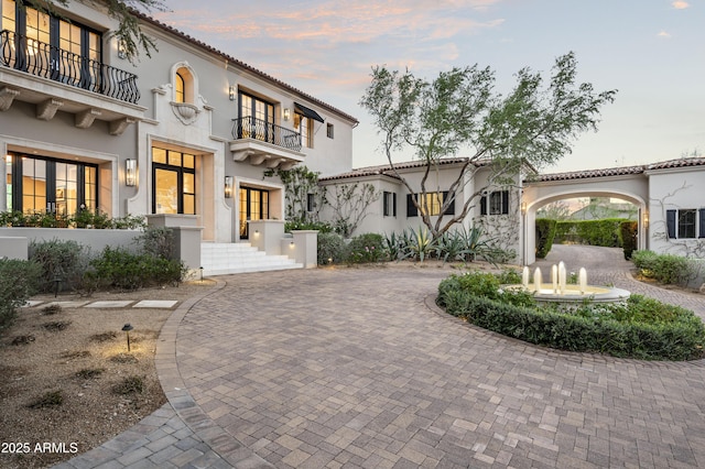 mediterranean / spanish-style home with a balcony