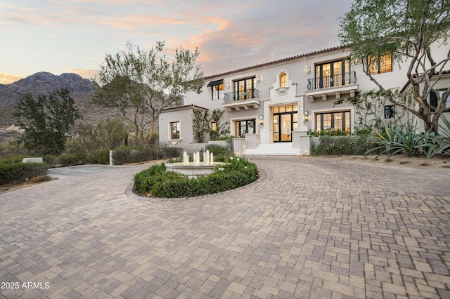 mediterranean / spanish-style home with a balcony and a mountain view