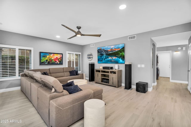 living room featuring visible vents, baseboards, recessed lighting, light wood-style floors, and a ceiling fan