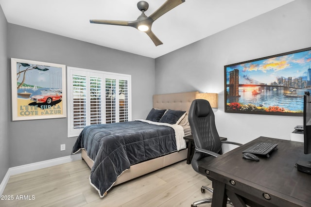 bedroom with baseboards, wood finished floors, and a ceiling fan