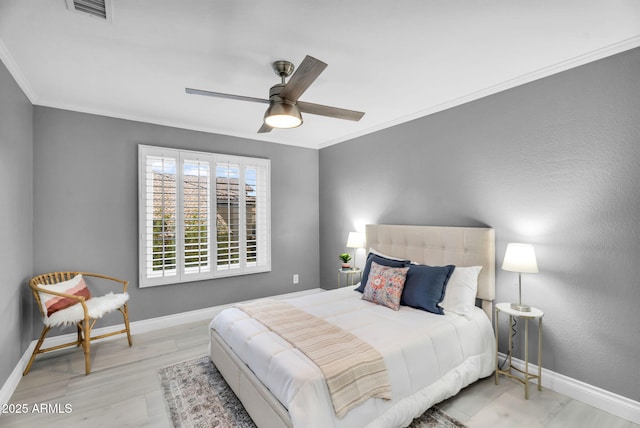 bedroom featuring visible vents, baseboards, and crown molding